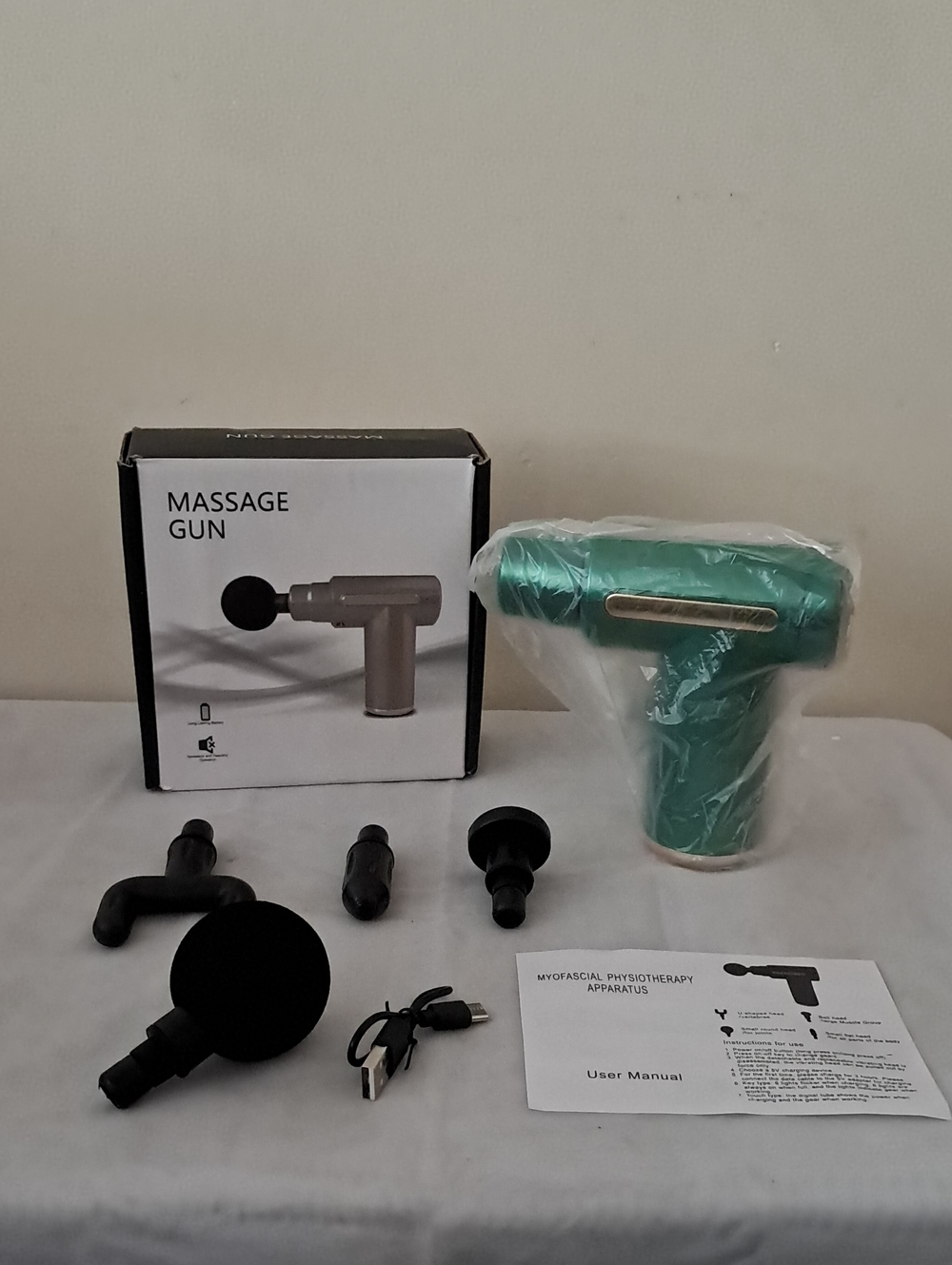 Green Massage Gun with Multiple Attachments